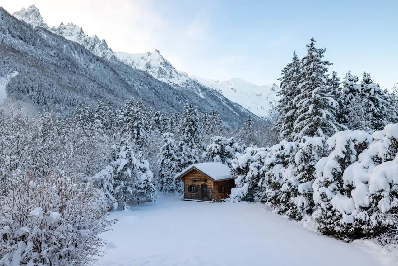 Serene alpine cabin nestled in winter wonderland snowy mountain landscape