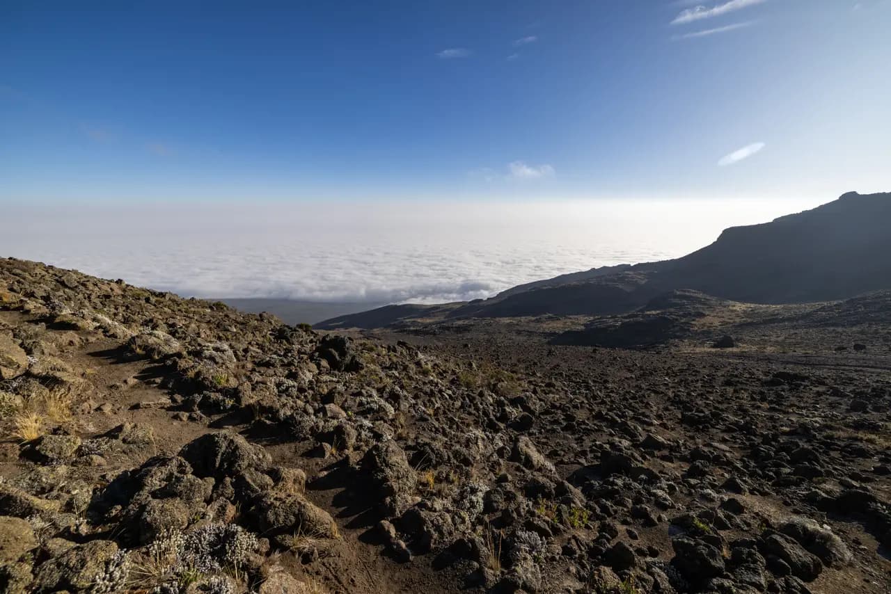 Panoramic view of volcanic mountain landscape above the clouds on a sunny day